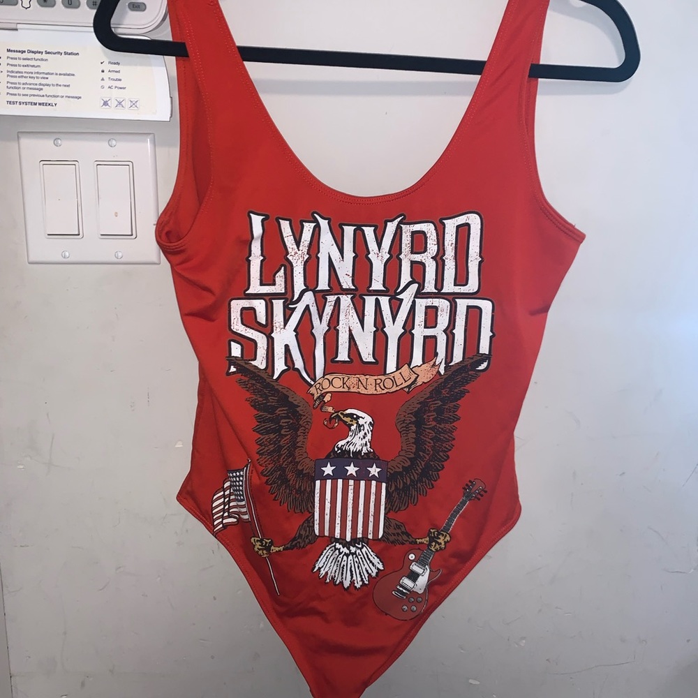 Orange graphic bodysuit. “Lynyrd Skynyrd” with American flag and eagle. No snaps